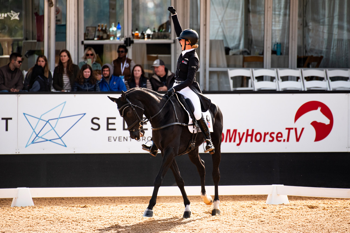 horse and rider celebrating after a great display in dressage