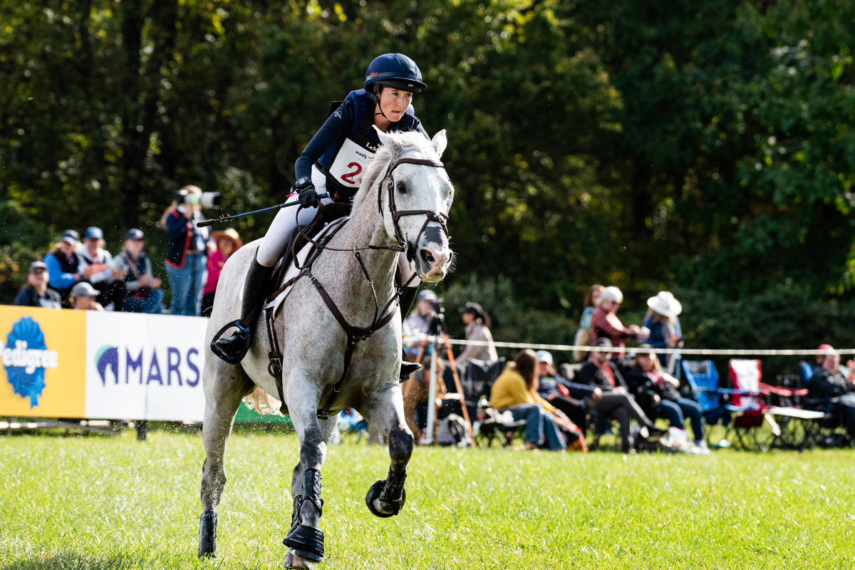Rider rounding the bend and getting her horse up to speed to tackle the next jump
