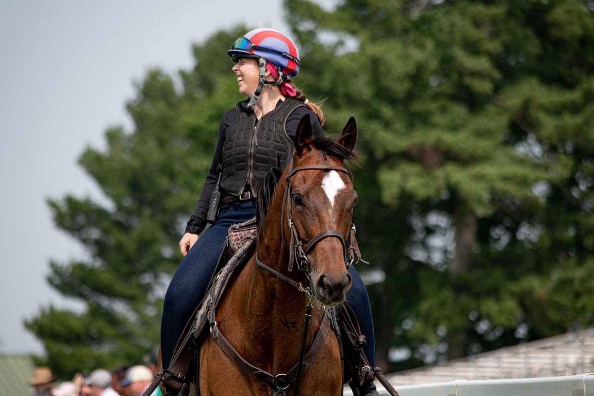 rider and her horse returning from their run both seem happy with the track.