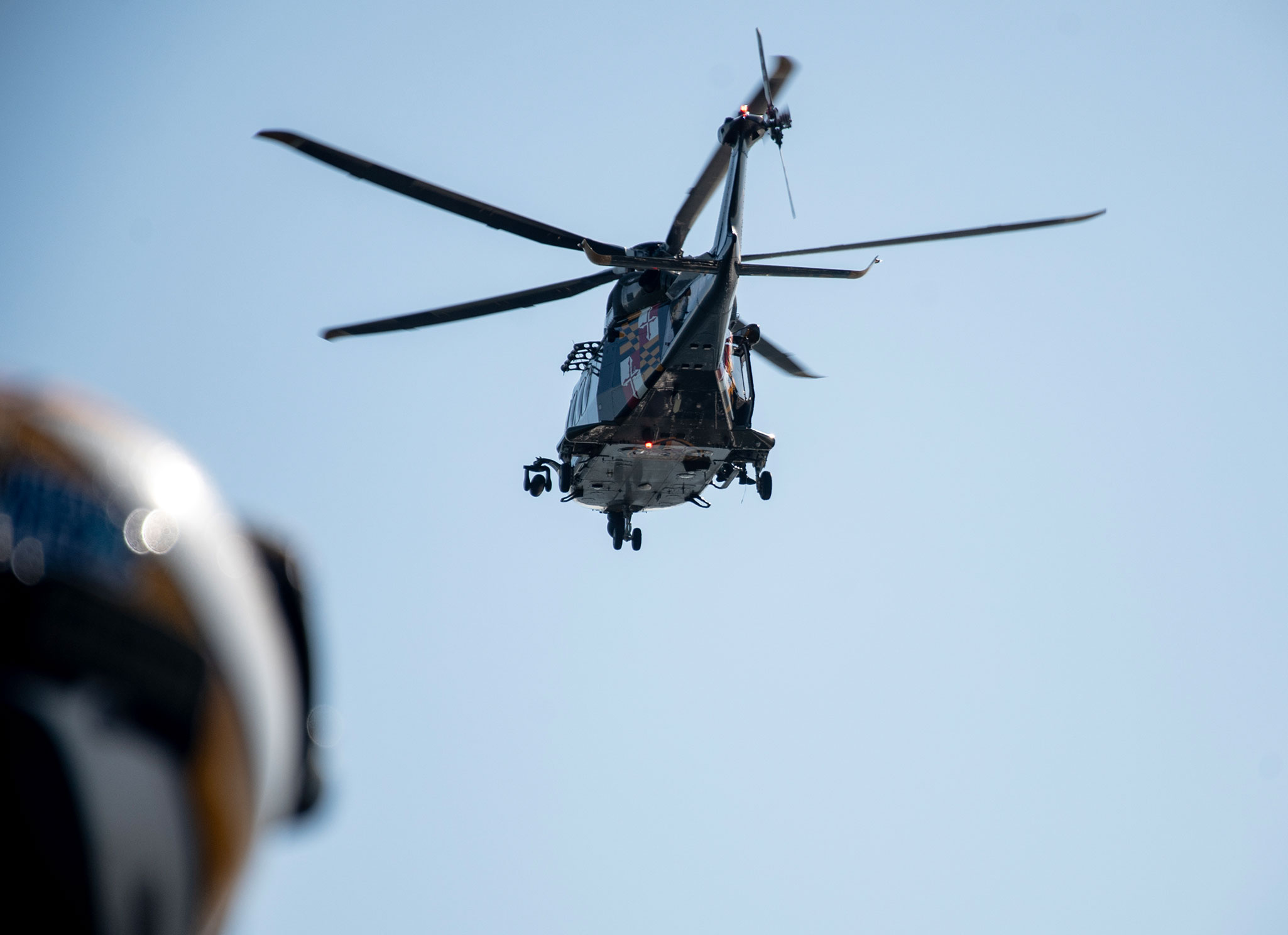 Helicopter moving away from the ship with a Trooper watching.