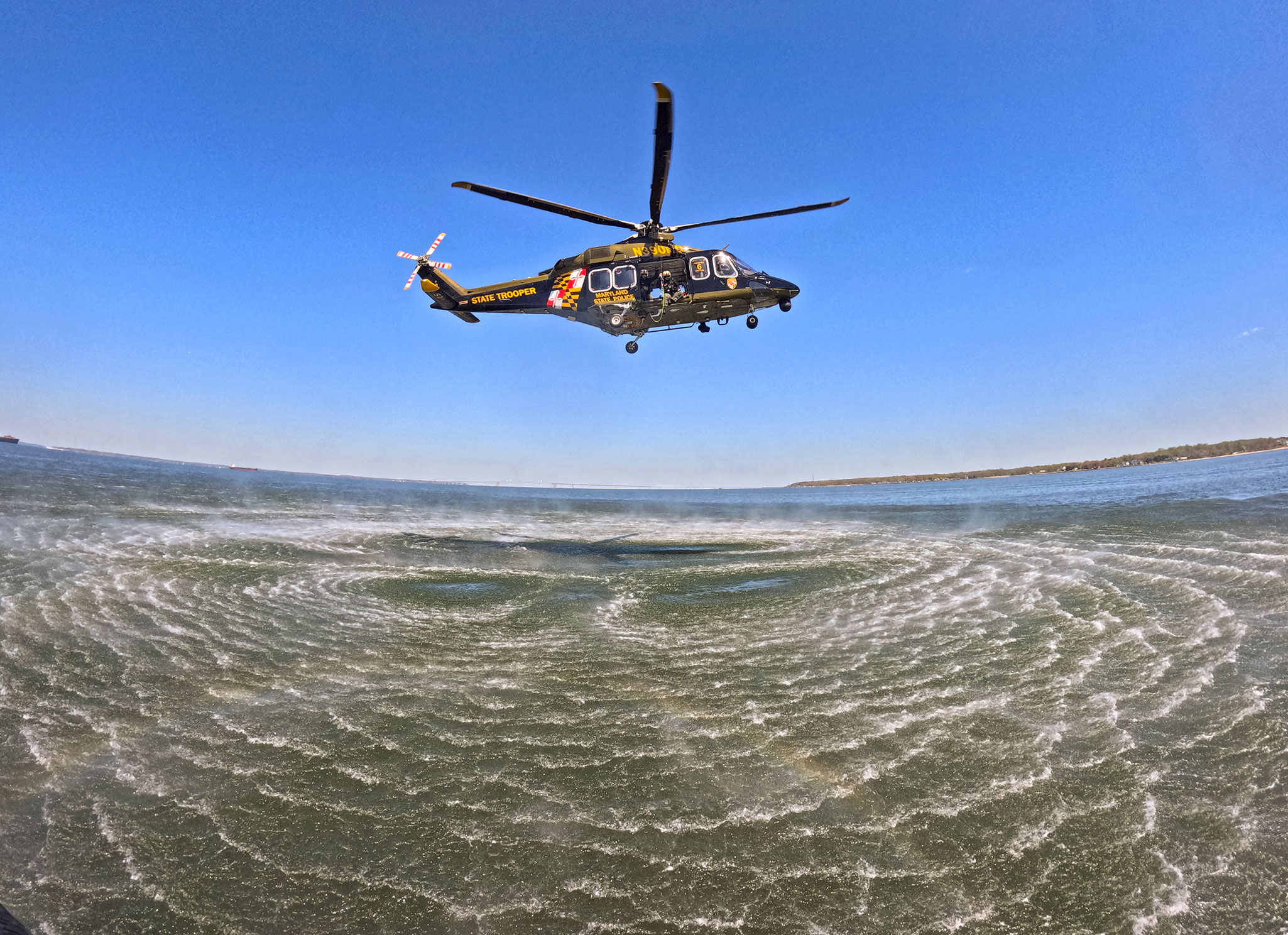 Helicopter kicking up spray from the bay as it gets close to the Sandusky