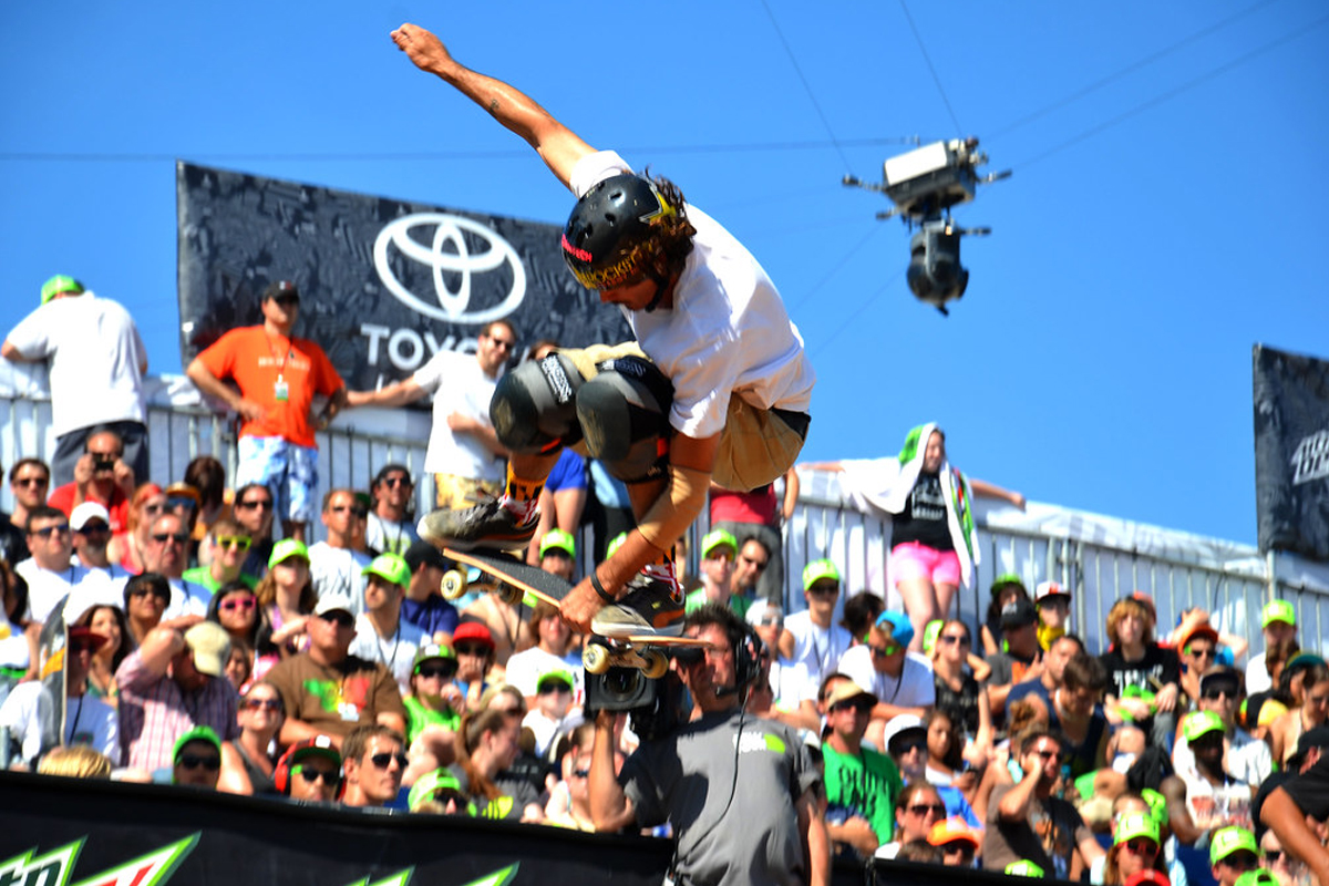 Skater flying by the crowd in the stands.