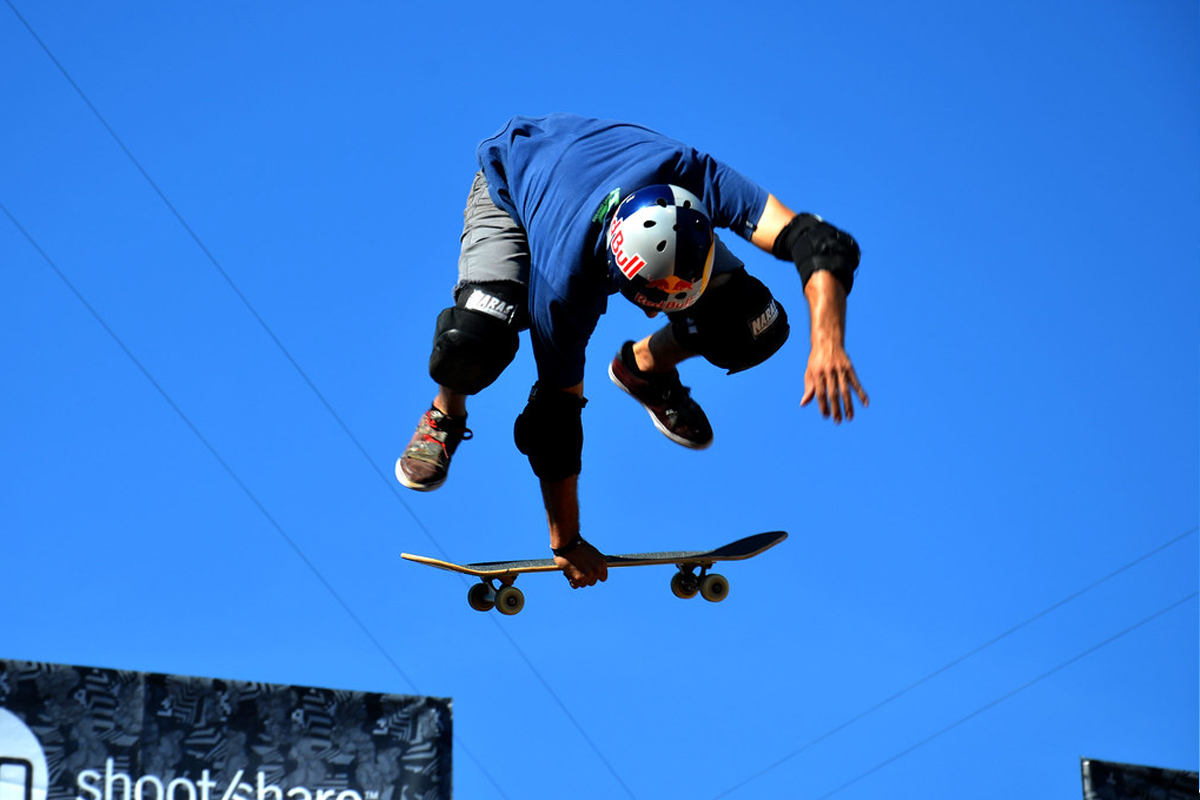 Skater in mid air, his board is just under his feet but not touching
