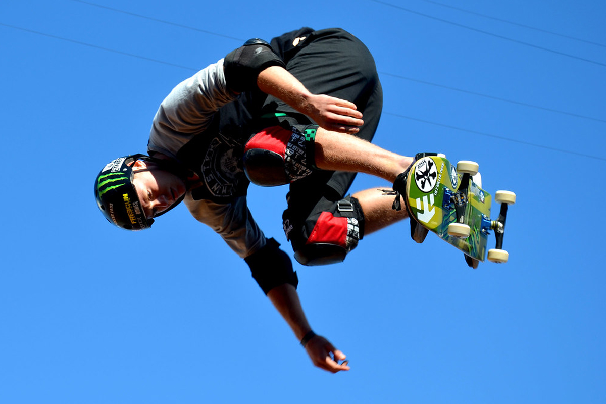 Skater in mid air, the board is on his feet but he's not using his hands.