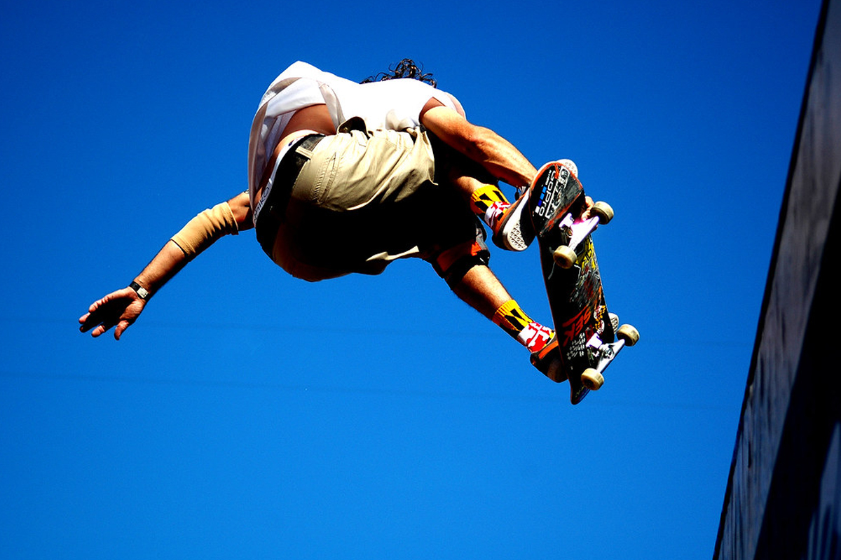 Skater off the half pipe with the crowd looking on.