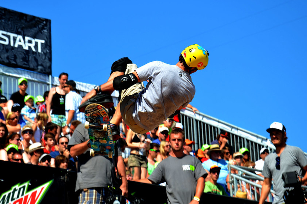 Skater off the half pipe with the crowd looking on.