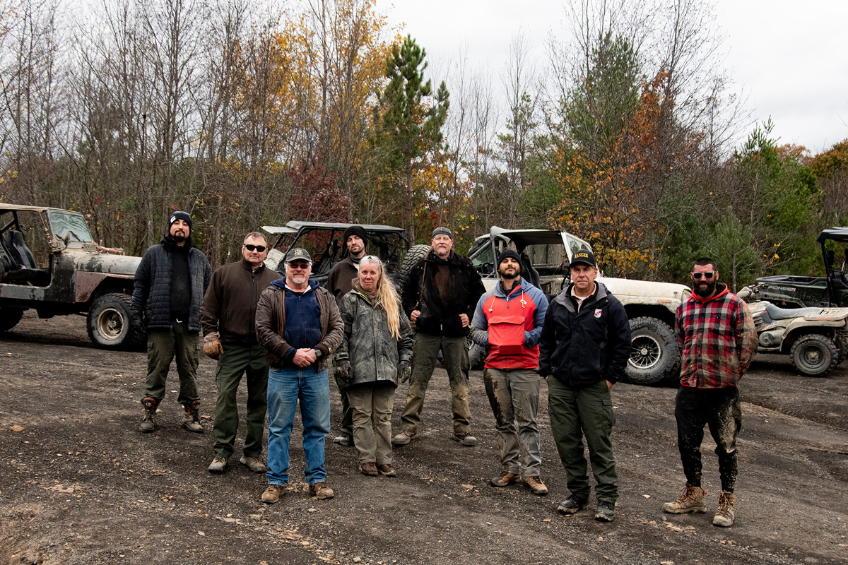 Photo of the driver group on the top of the mountain. Jeeps, atv, side-by-side and motor cycle in the background.
